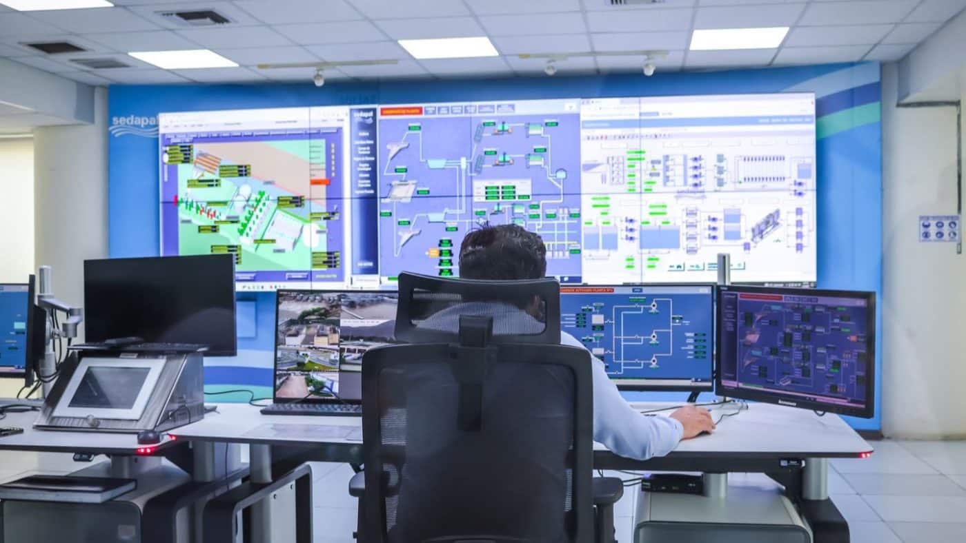 Operator managing surveillance footage across several screens
