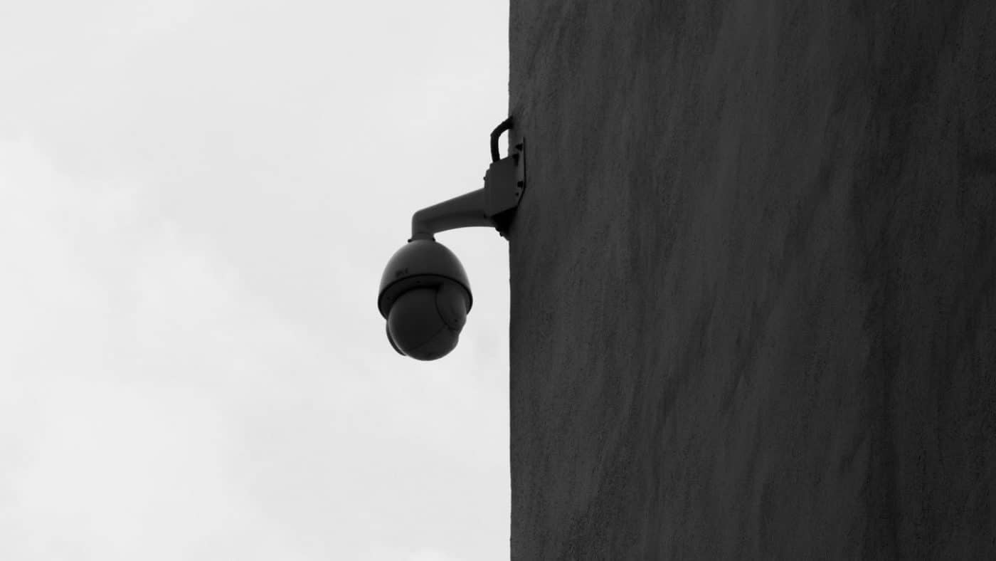 Black and white CCTV camera mounted on a building corner