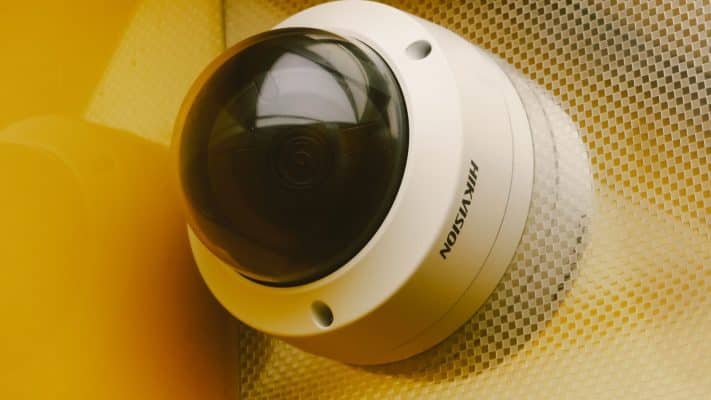 Security camera mounted on a building wall at dusk